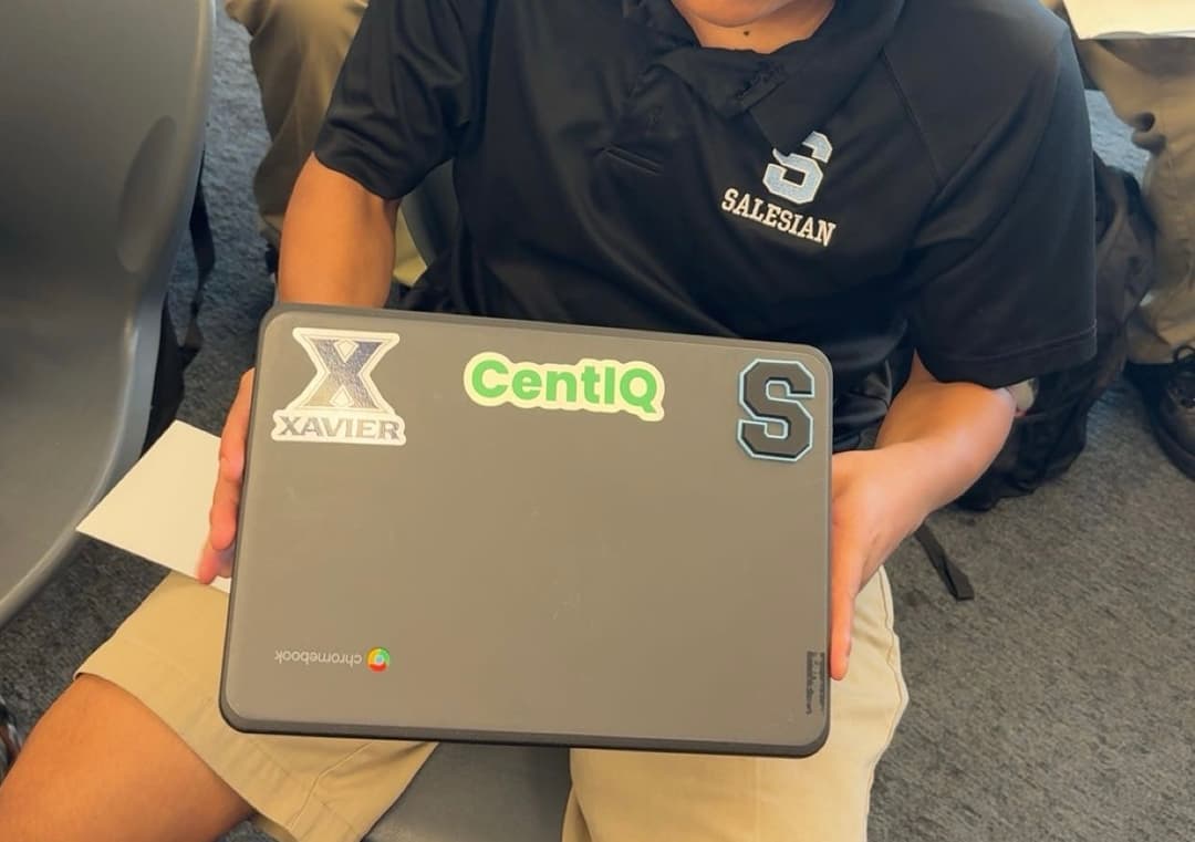 Student with CentIQ sticker on laptop
